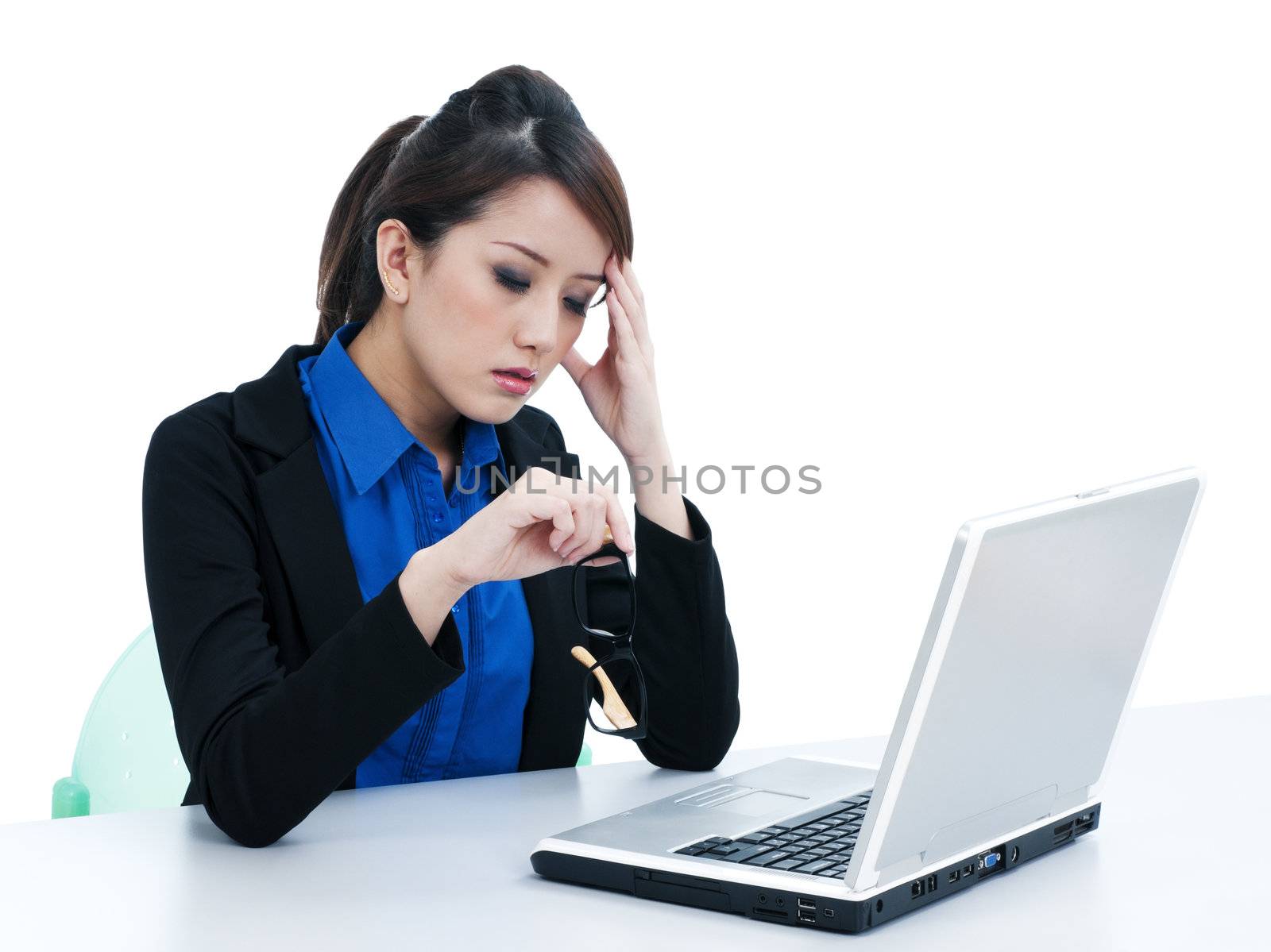 Portrait of a tired young businesswoman with laptop and her hand on head over white background.