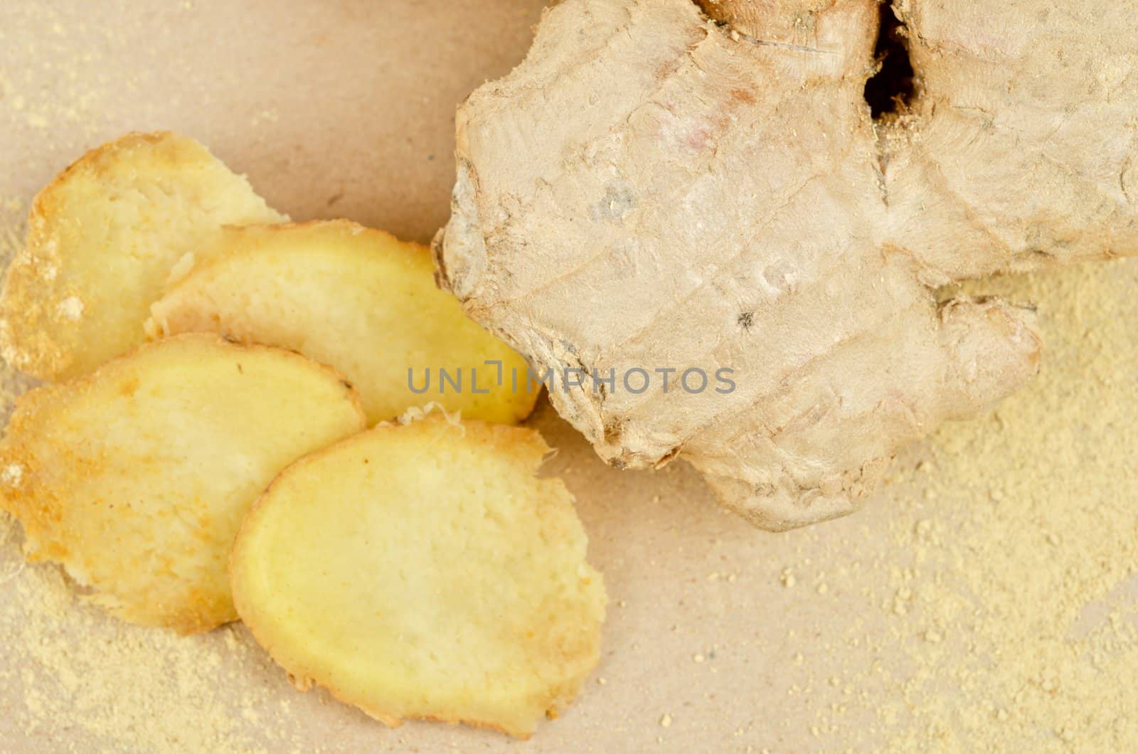 Fresh, dried and powdered ginger at brown background
