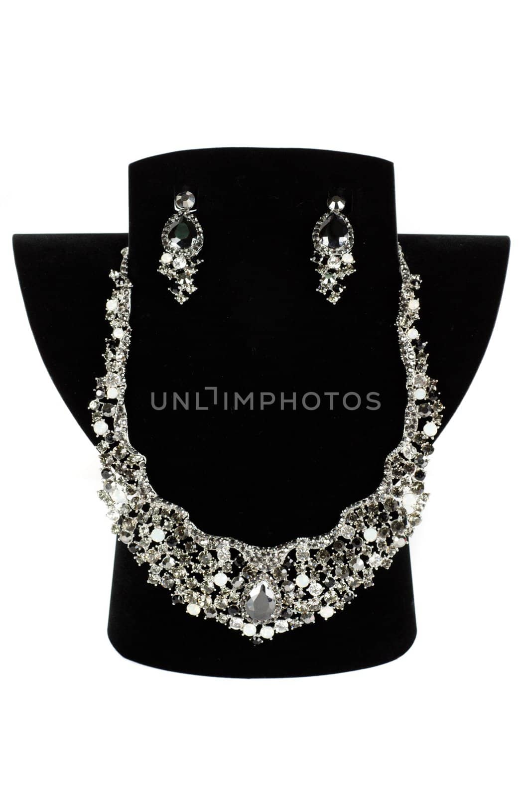 a necklace with pendants and earrings on a white background