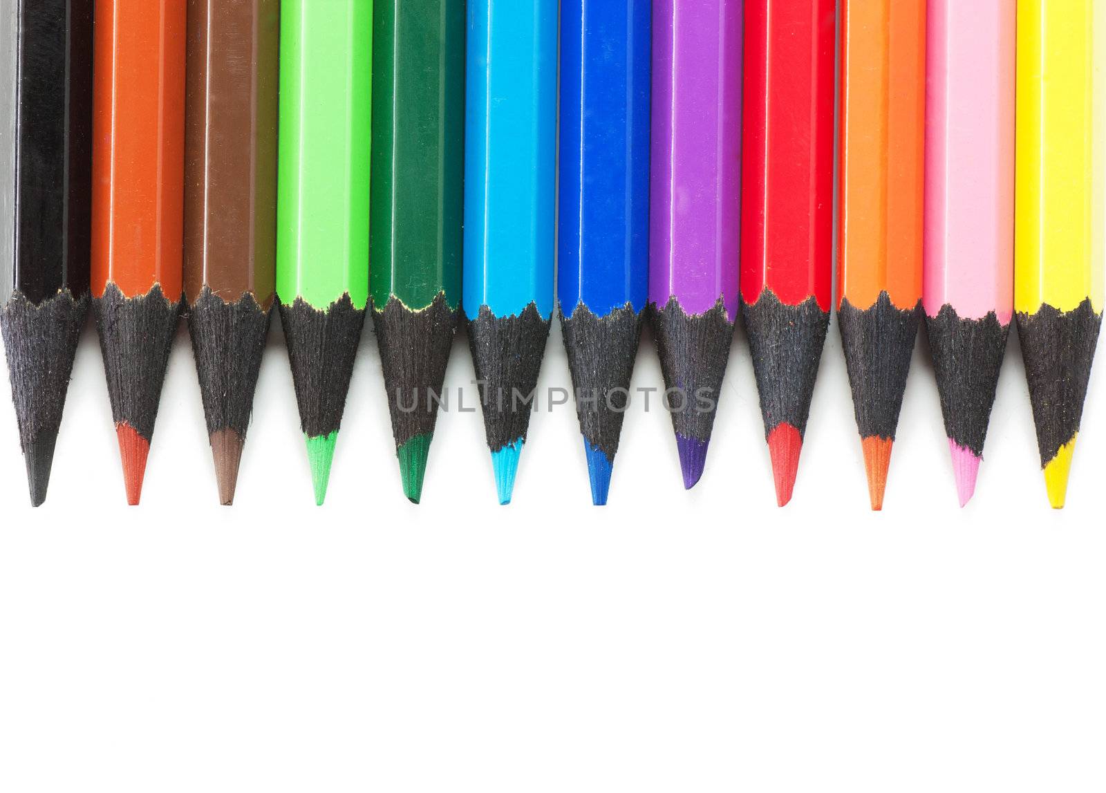 Colored pencils isolated over white background