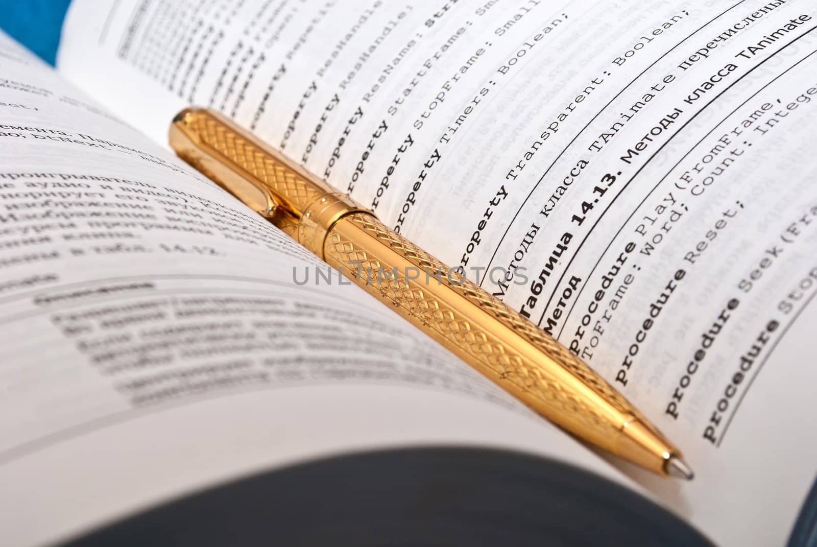 Education or reading concept with book and golden pen