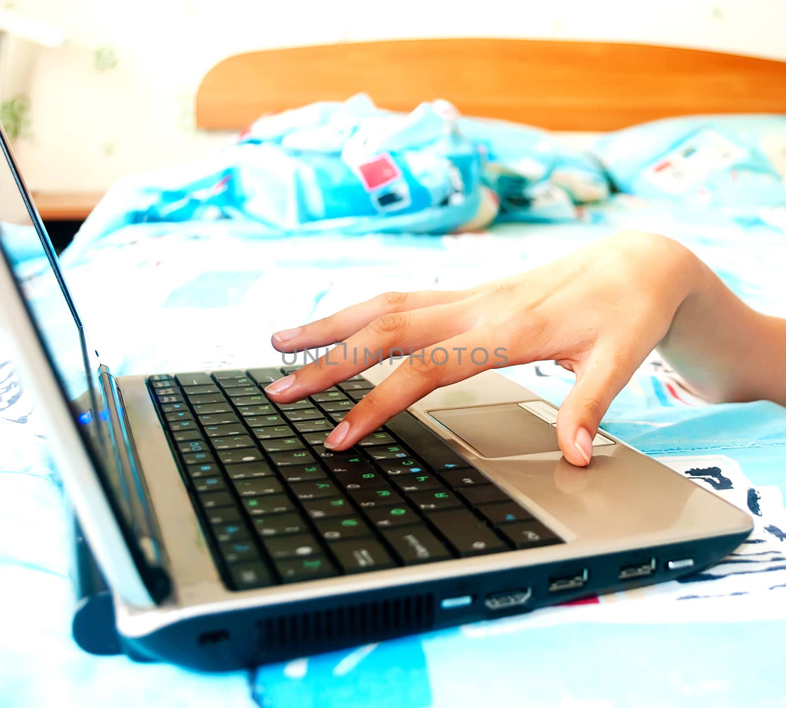Female hands typing on a laptop by Diversphoto