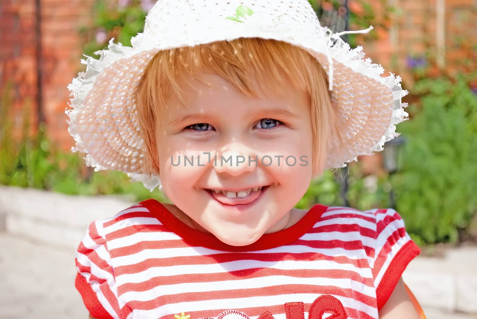 Portrait of a young girl in a white hat