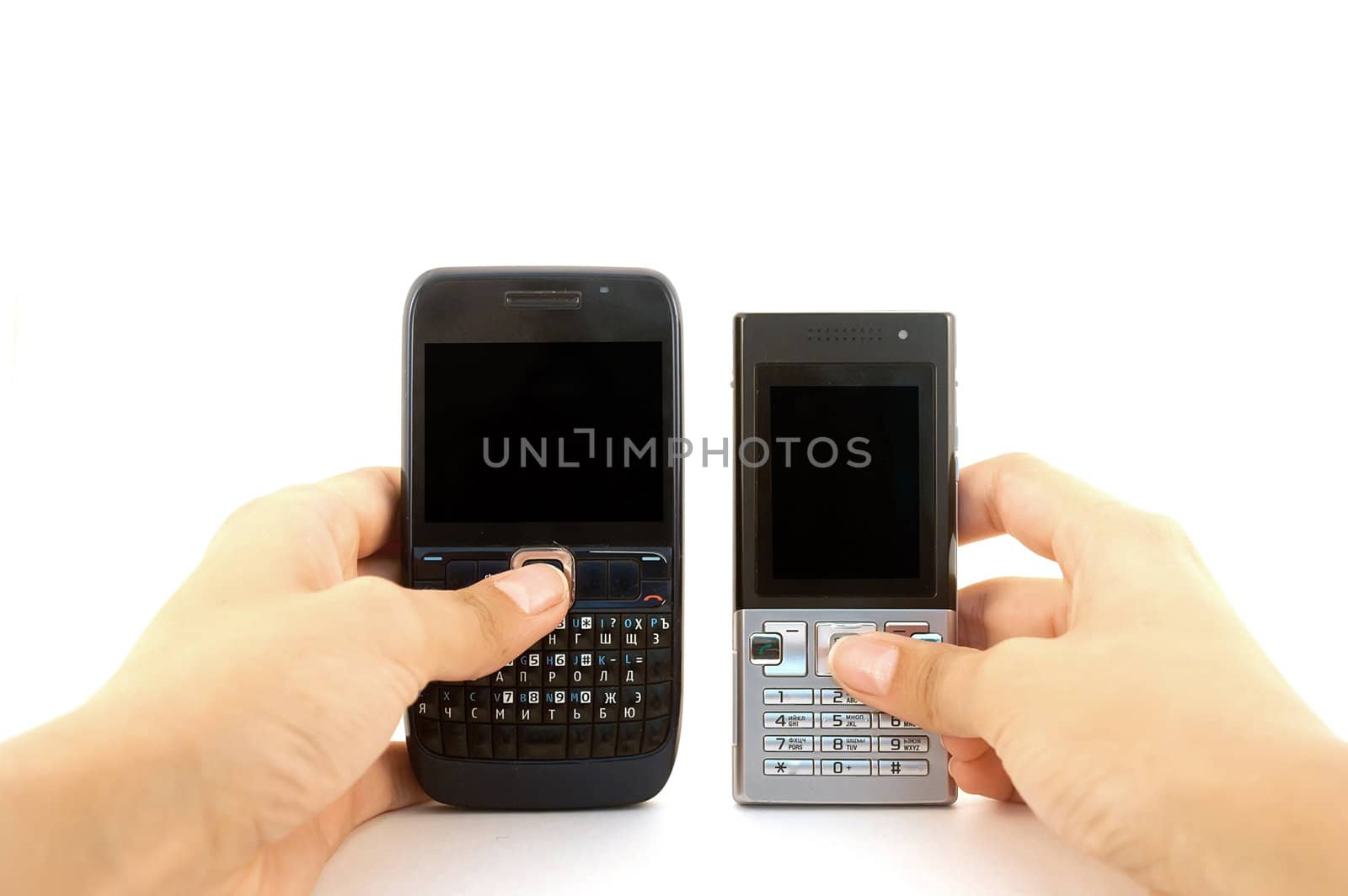 Two mobile phones in hands over white by Diversphoto
