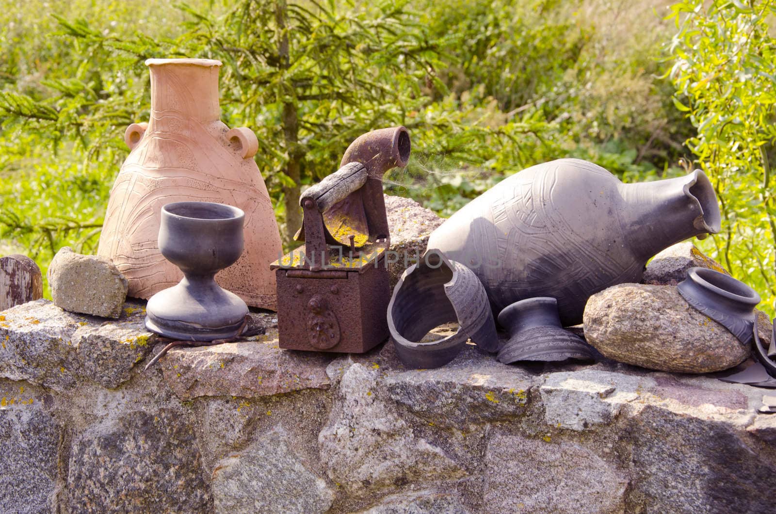 Antique iron tool. Handmade wares made of clay and their fragments.