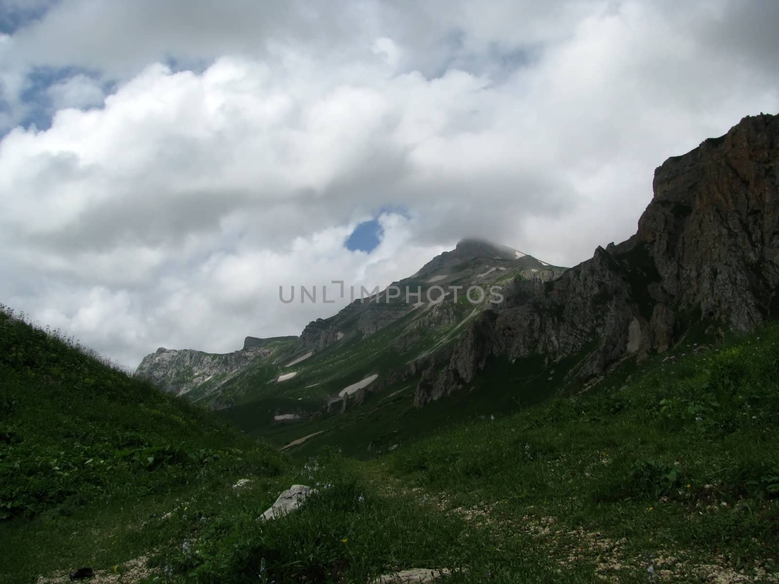 Mountains, rocks; a relief; a landscape; a hill; a panorama; Caucasus; top; a slope; clouds; the sky; a landscape