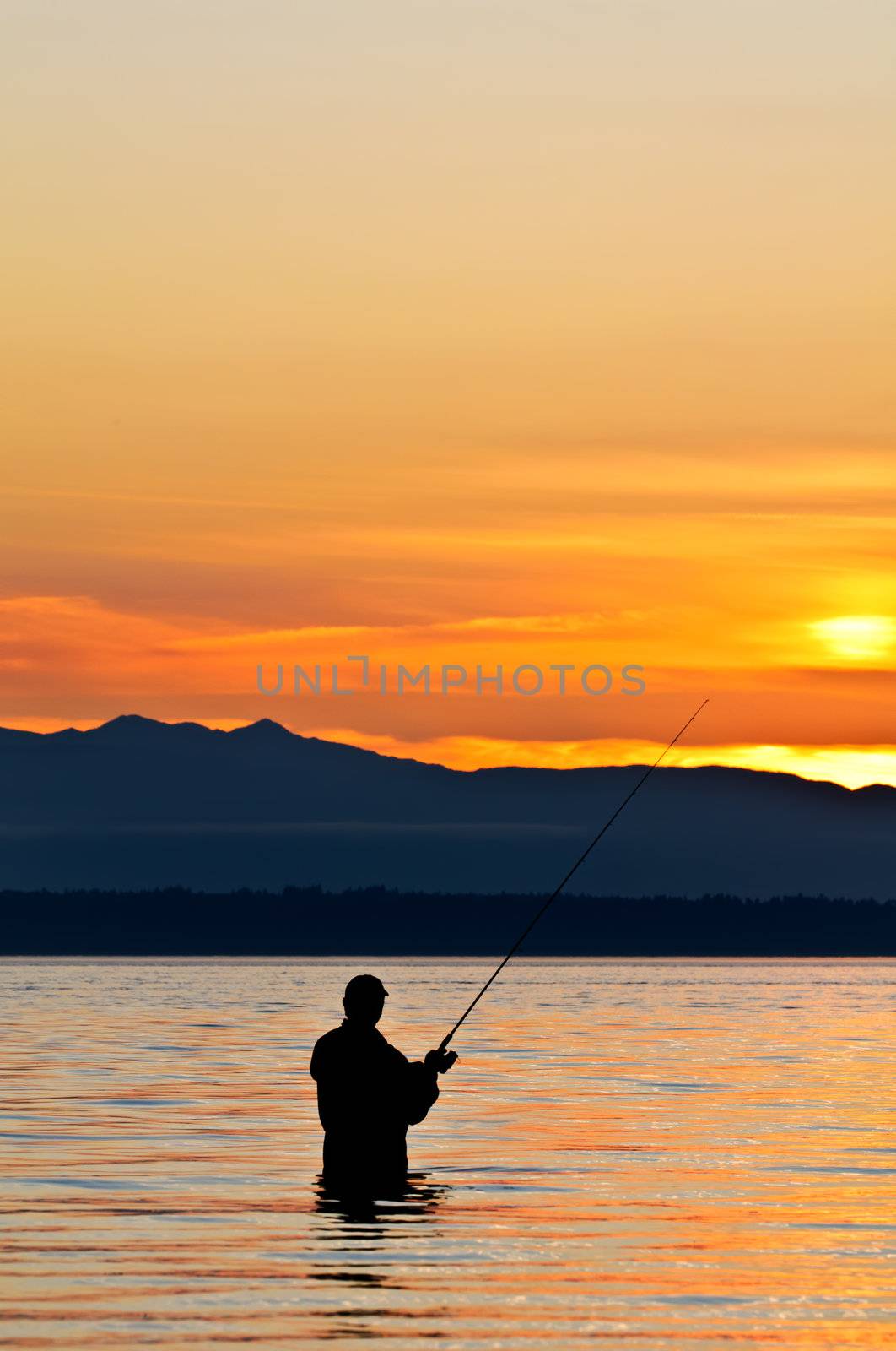 Silhouette of a fisherman with a fishing pole at sunset. by lobzik