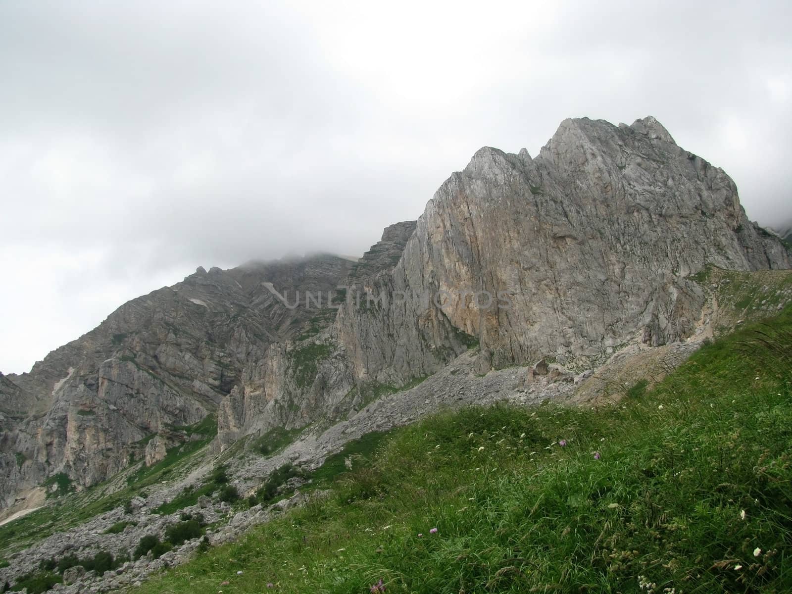 Mountains; rocks; a relief; a landscape; a hill; a panorama; Caucasus; top; a slope; clouds; the sky; a landscape