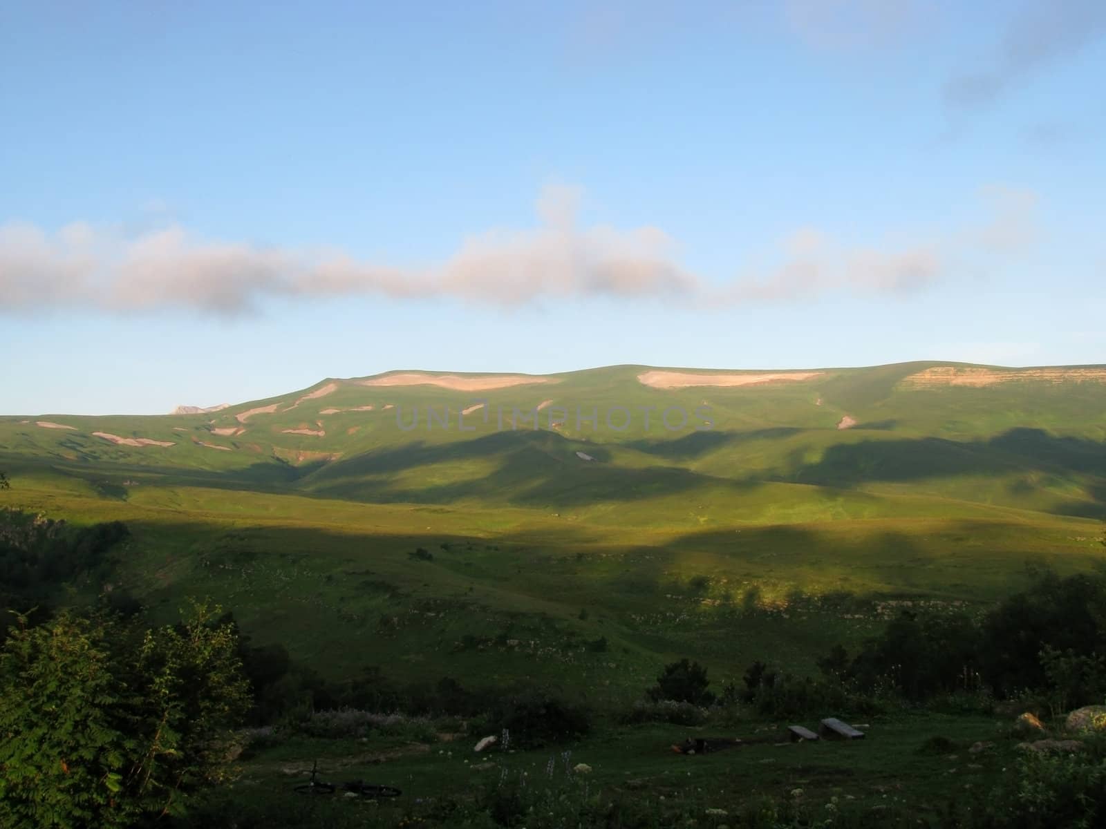 Mountains; rocks; a relief; a landscape; a hill; a panorama; Caucasus; top; a slope; clouds; the sky; a landscape