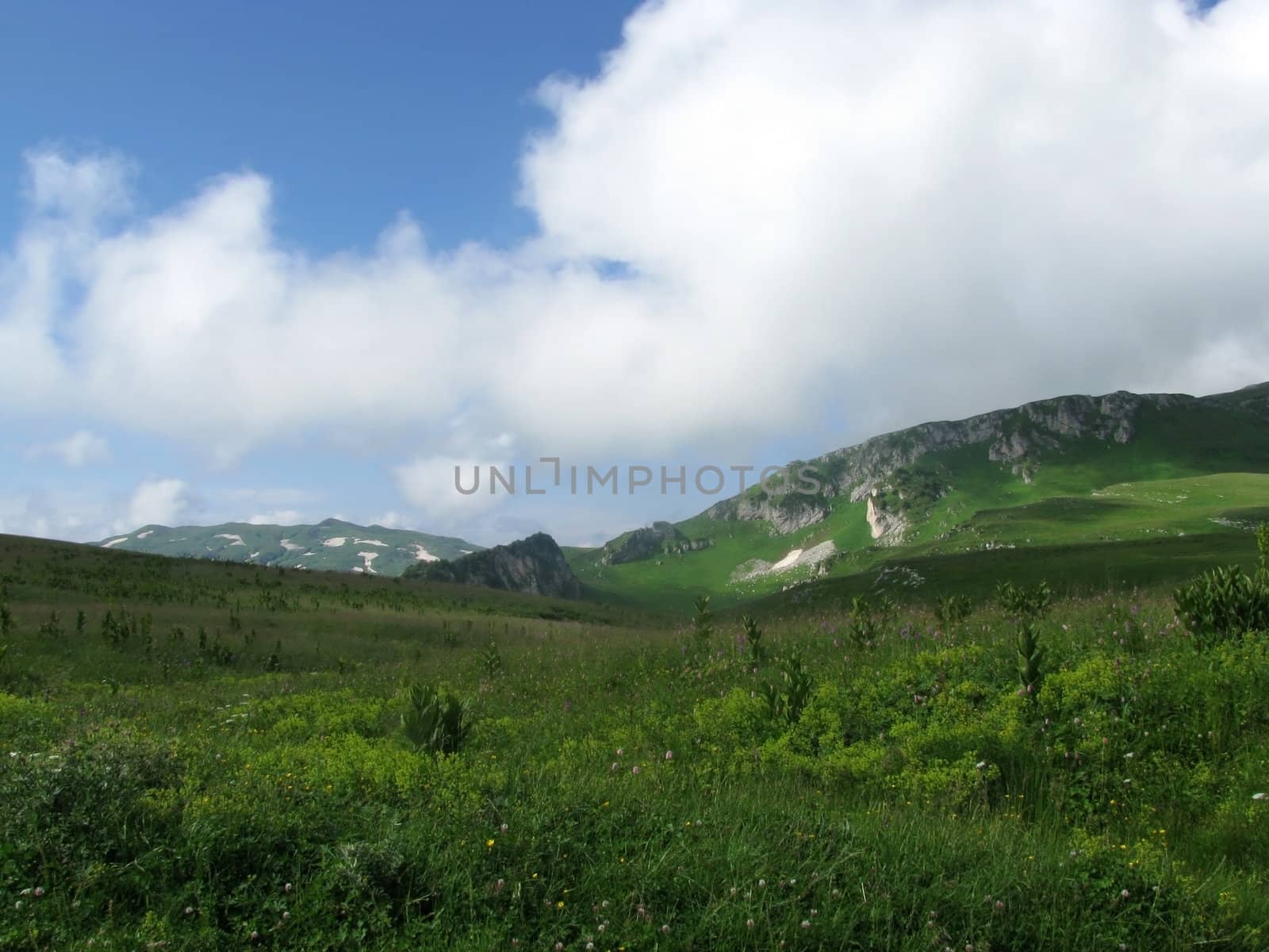 Mountains; rocks; a relief; a landscape; a hill; a panorama; Caucasus; top; a slope; clouds; the sky; a landscape