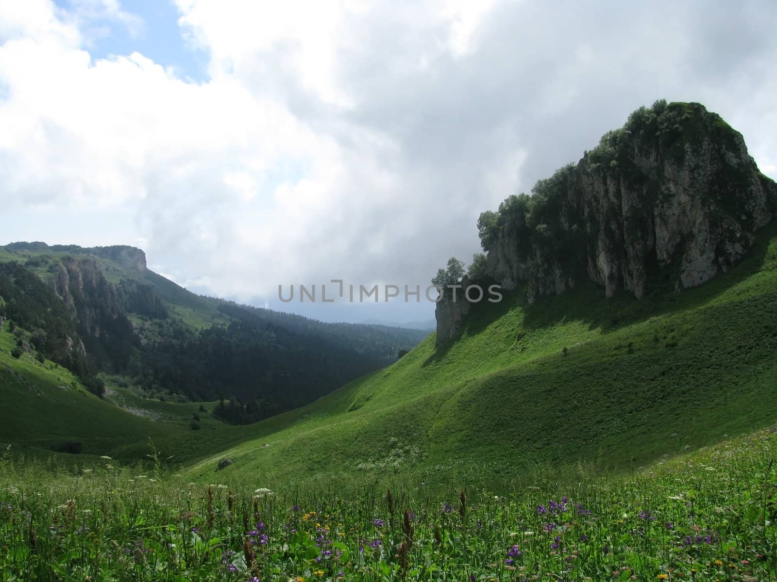 Mountains; rocks; a relief; a landscape; a hill; a panorama; Caucasus; top; a slope; clouds; the sky; a landscape