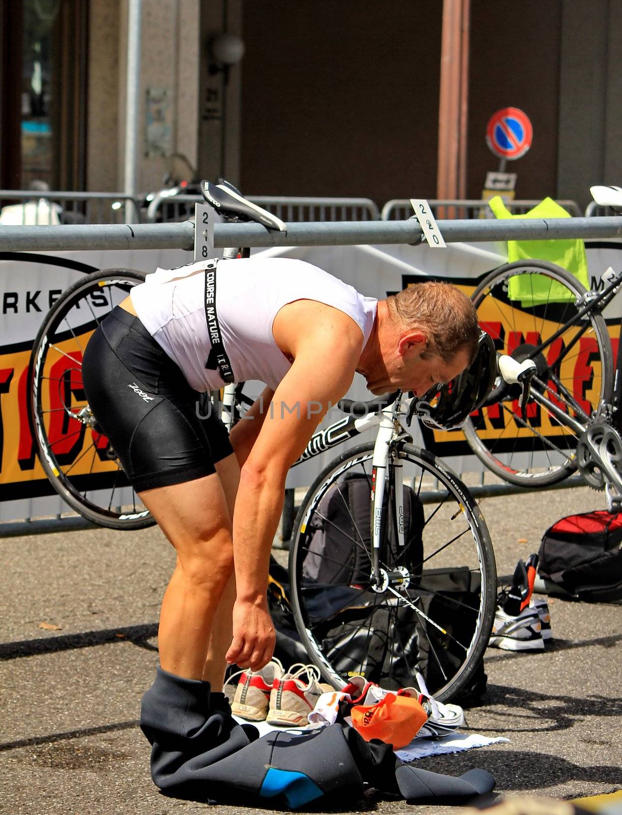 GENEVA, SWITZERLAND - JULY 24 : one unidentified male racing cyclist after the swimm race at the international Geneva Triathlon, on july 24, 2011 in Geneva, Switzerland