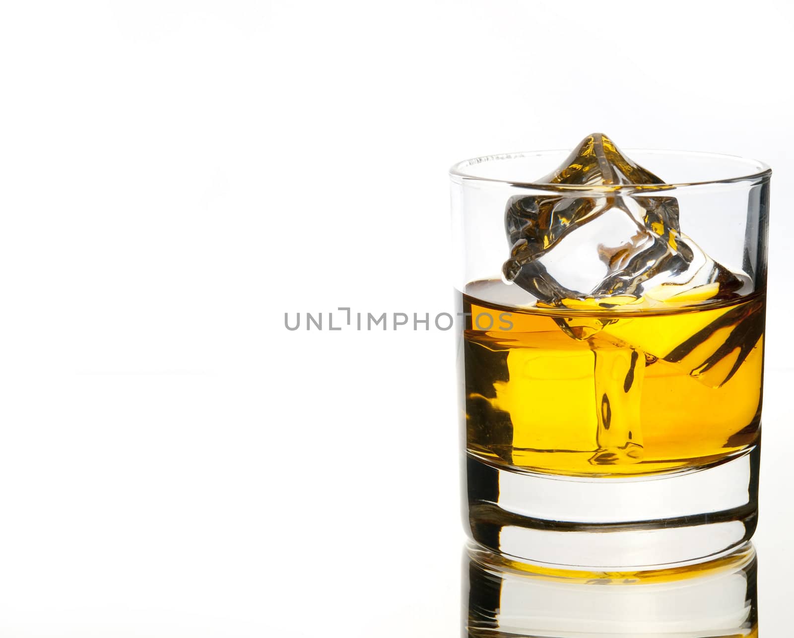 whiskey on the rocks on white with reflection