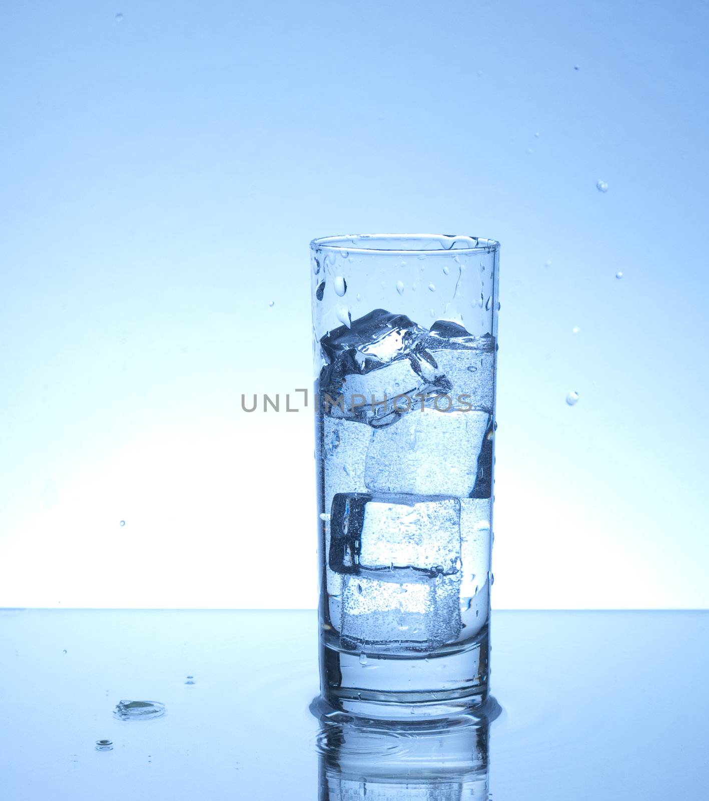 Glass of water with four ice cubes