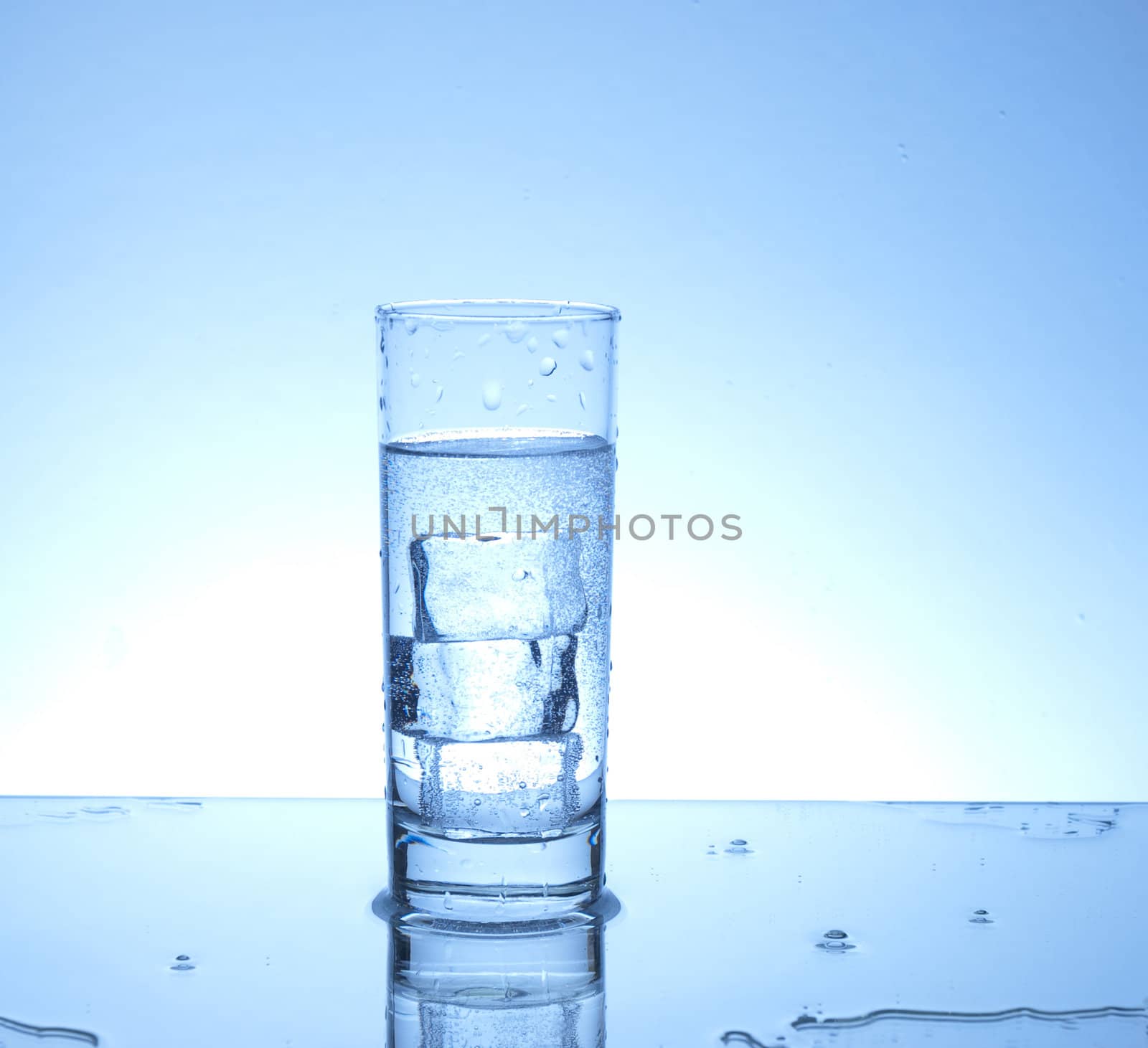 Three ice cubes in a glass of water 