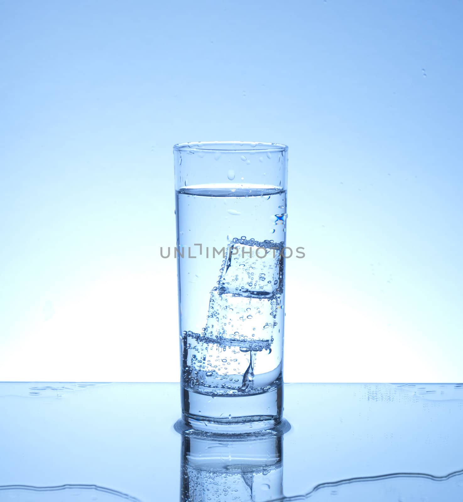 Glass of water with three ice cubes