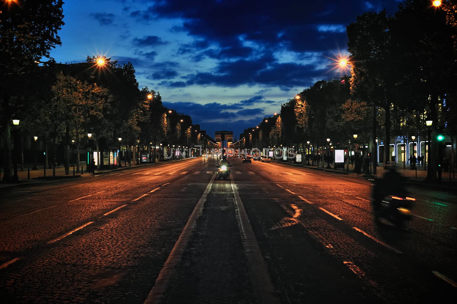 Champs-Elysees avenue and the Triumphal Arch at night