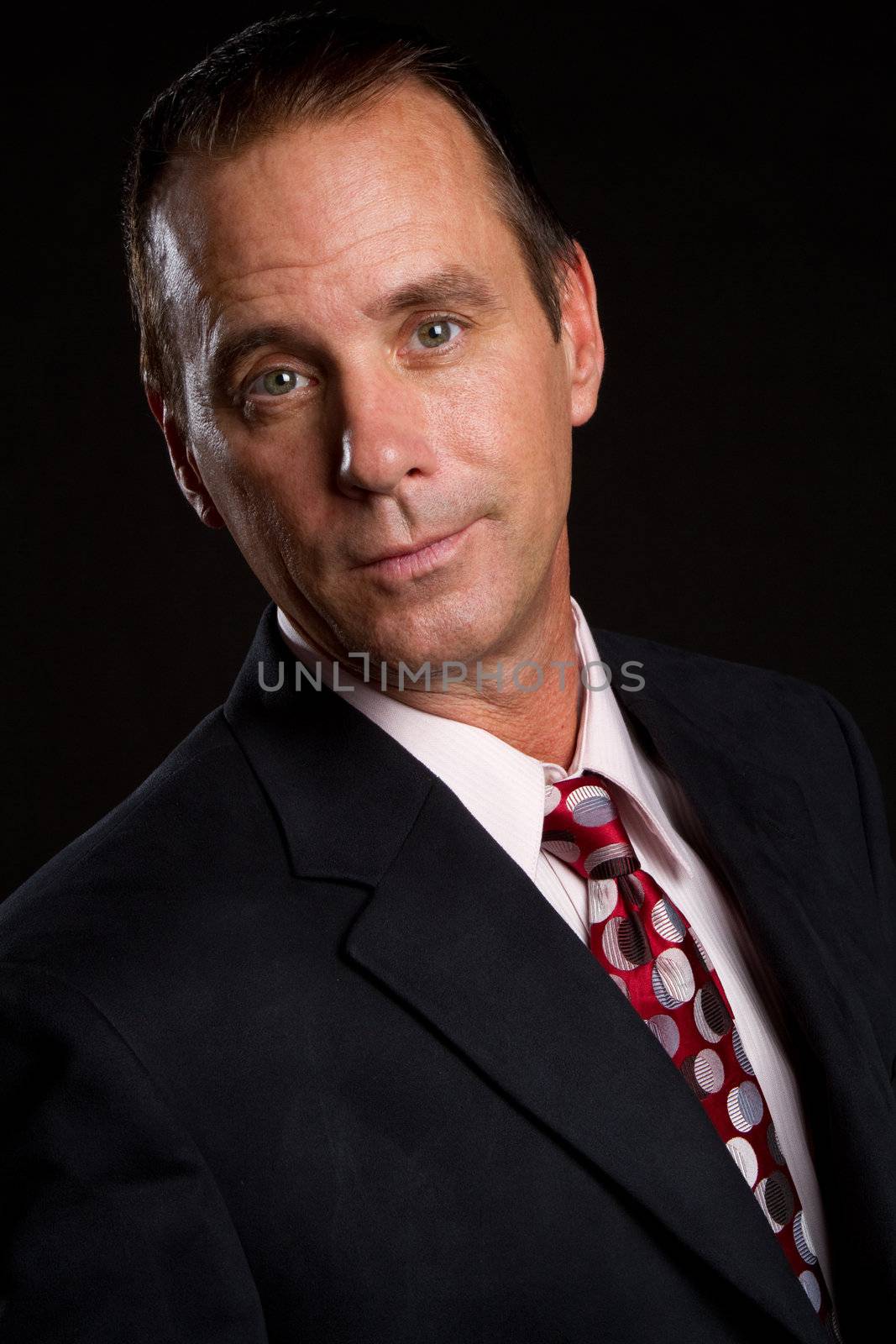 Businessman headshot wearing suit tie