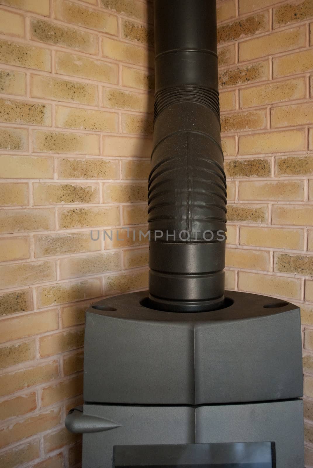 Heating stove next to a brickwall