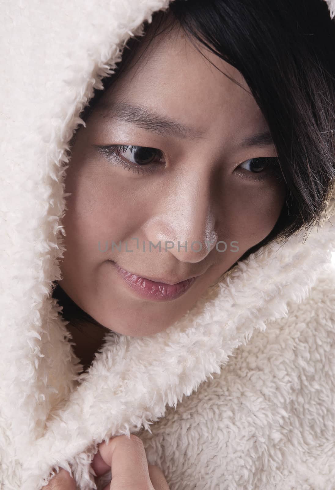 Beautiful young woman in winter outerwear on white