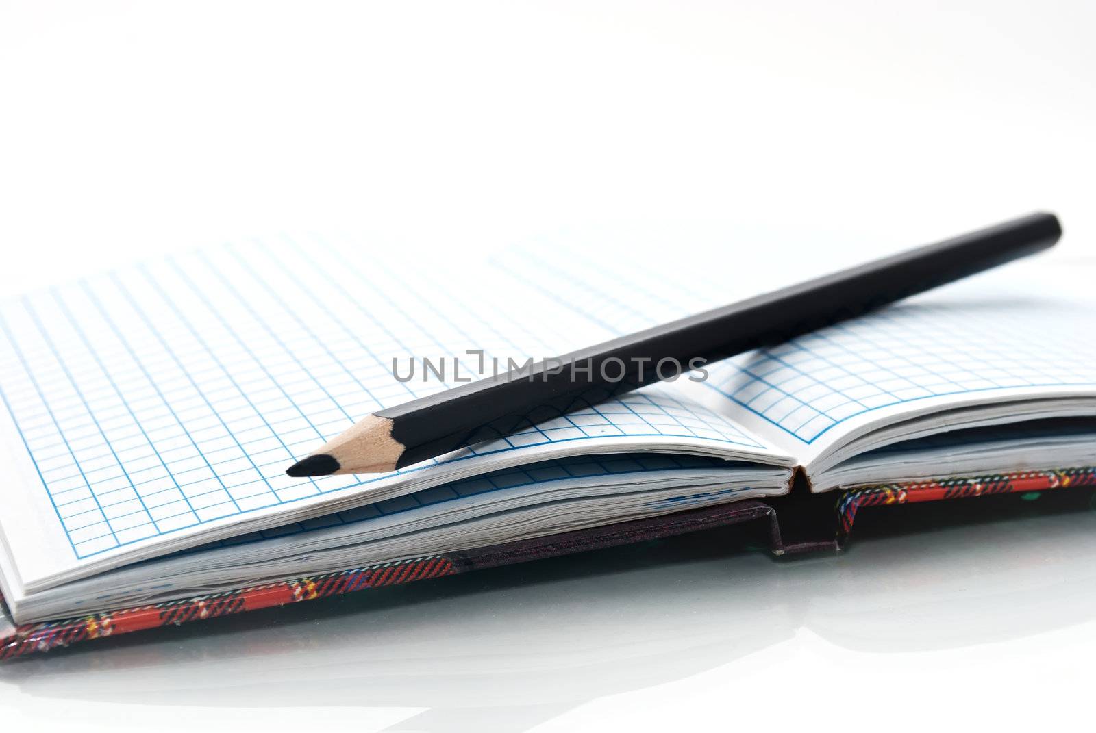 close up of notebook and pencil by Diversphoto