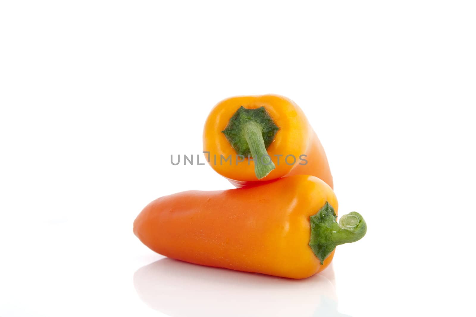 Two sweet orange peppers isolated on white.