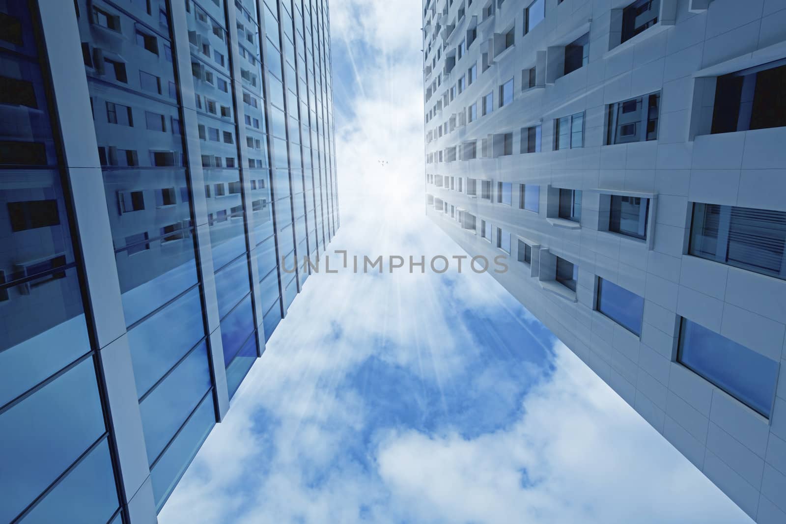 City skyscrapers with blue sky and sunbeams