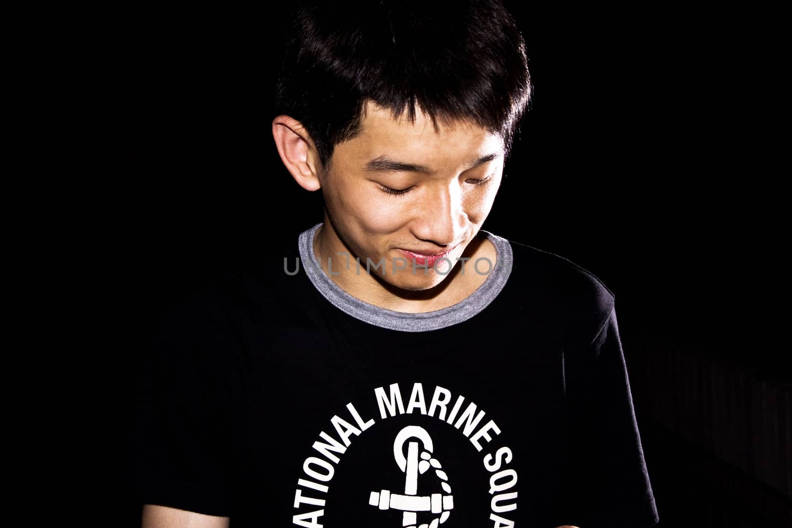 portrait of handsome smiley man over dark background ,chinese