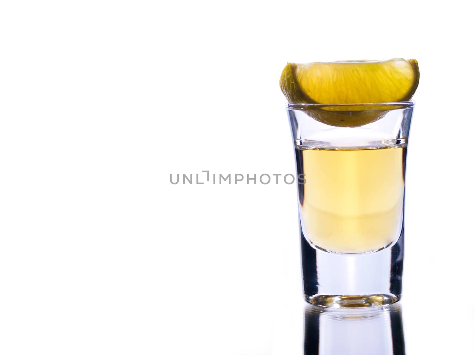 Tequila shot and lime on white