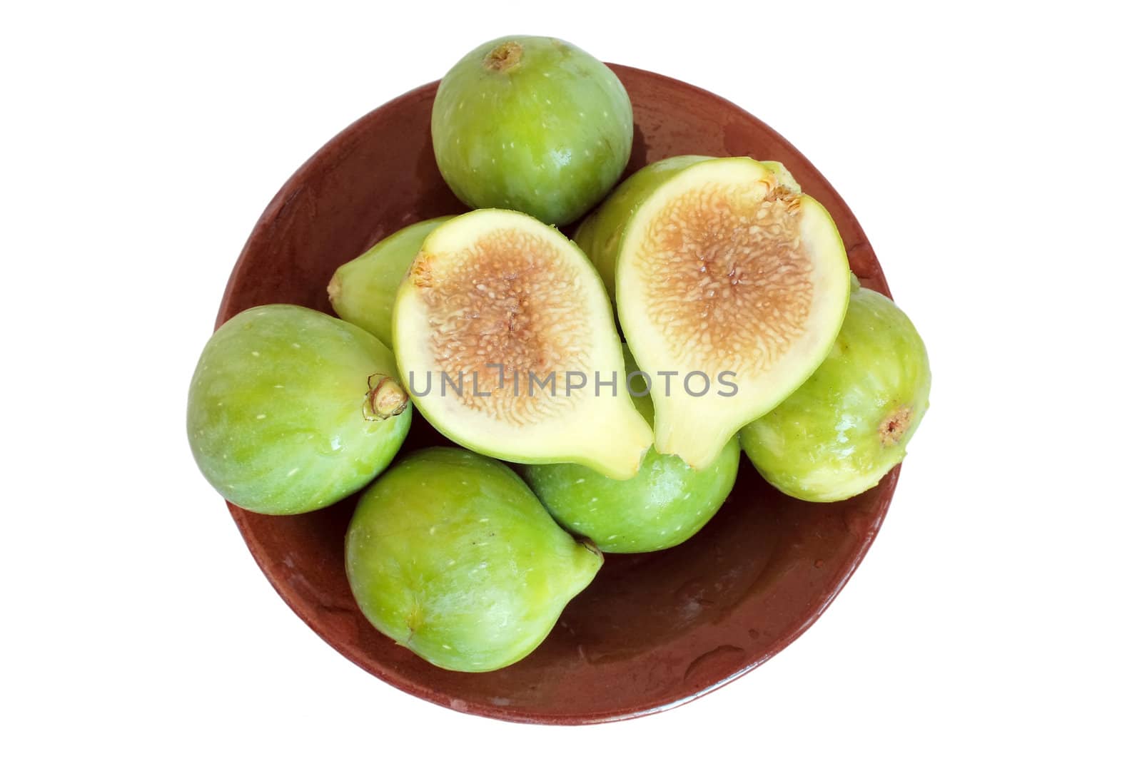 Green figs on plate in isolated over white