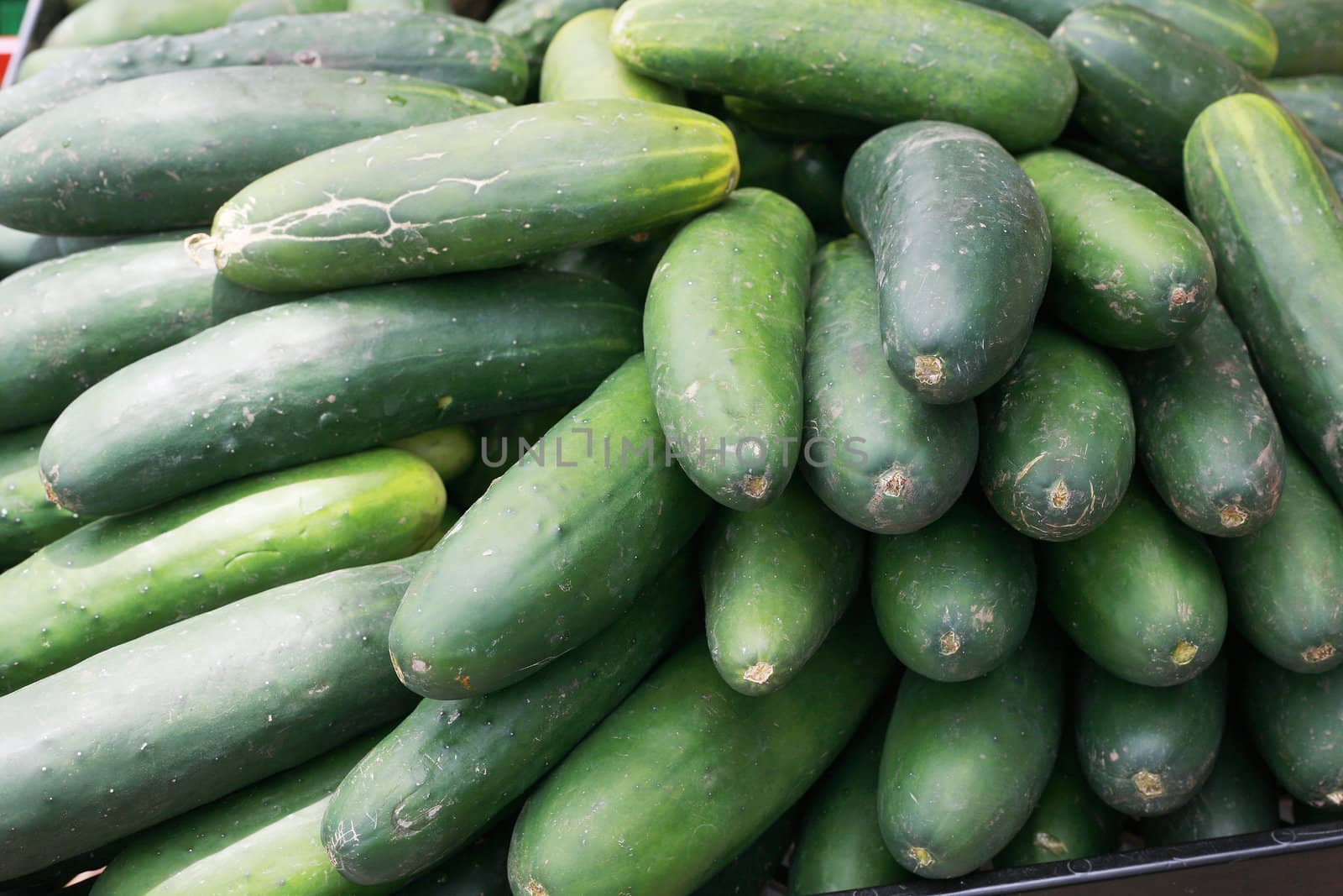 cucumbers bunched together for sale at market good as a background