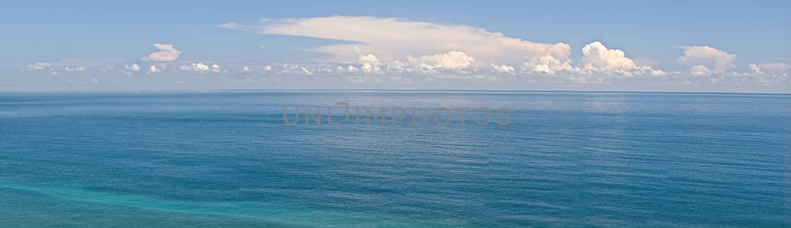 Panoramic seascape with blue water and sky.