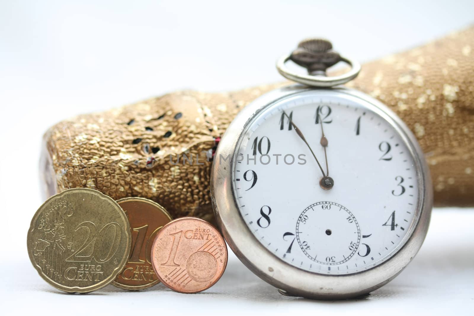 A champagne bottle, a vintage pocket watch and three euro coins making 2011. Perfect New Years greeting card