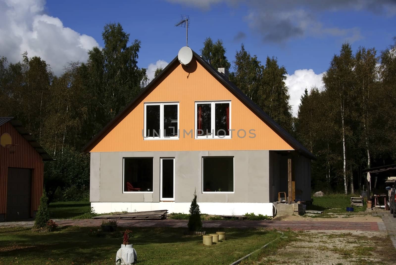 The modern house  on the background of the forest 