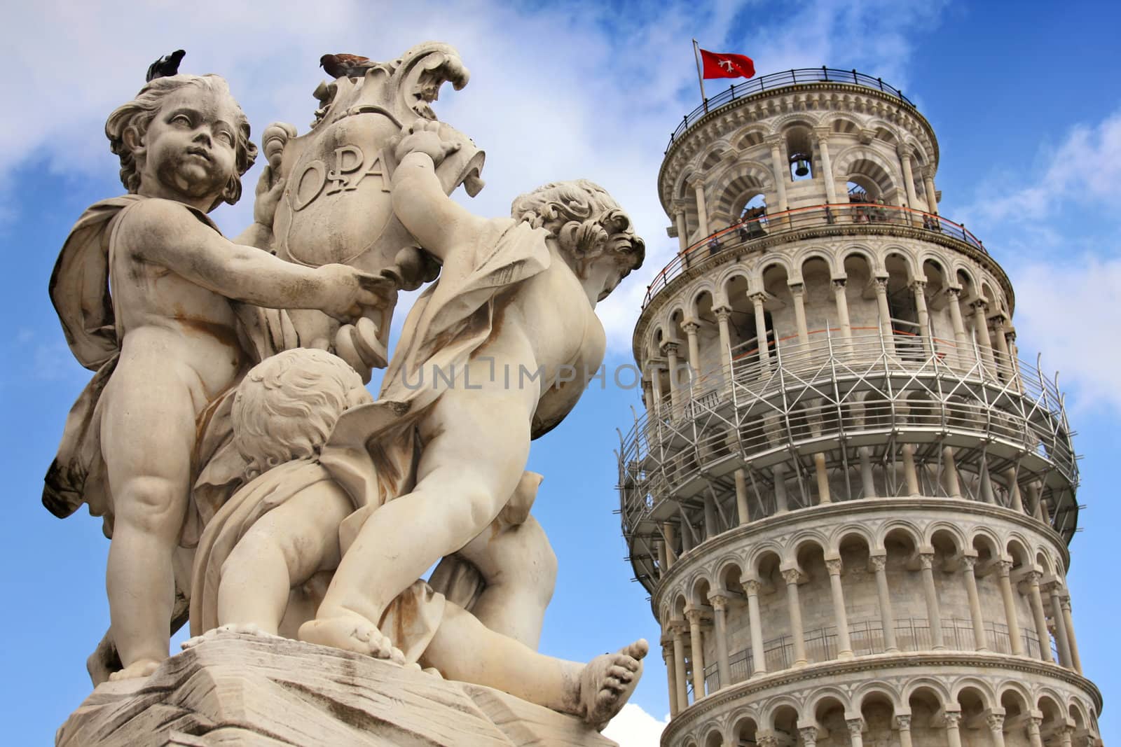Leaning tower and statue angel in Pisa, Tuscany, Italy 