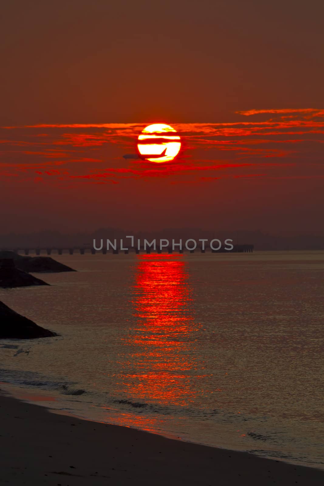 Airplane Flying over the horizon at Sunrise