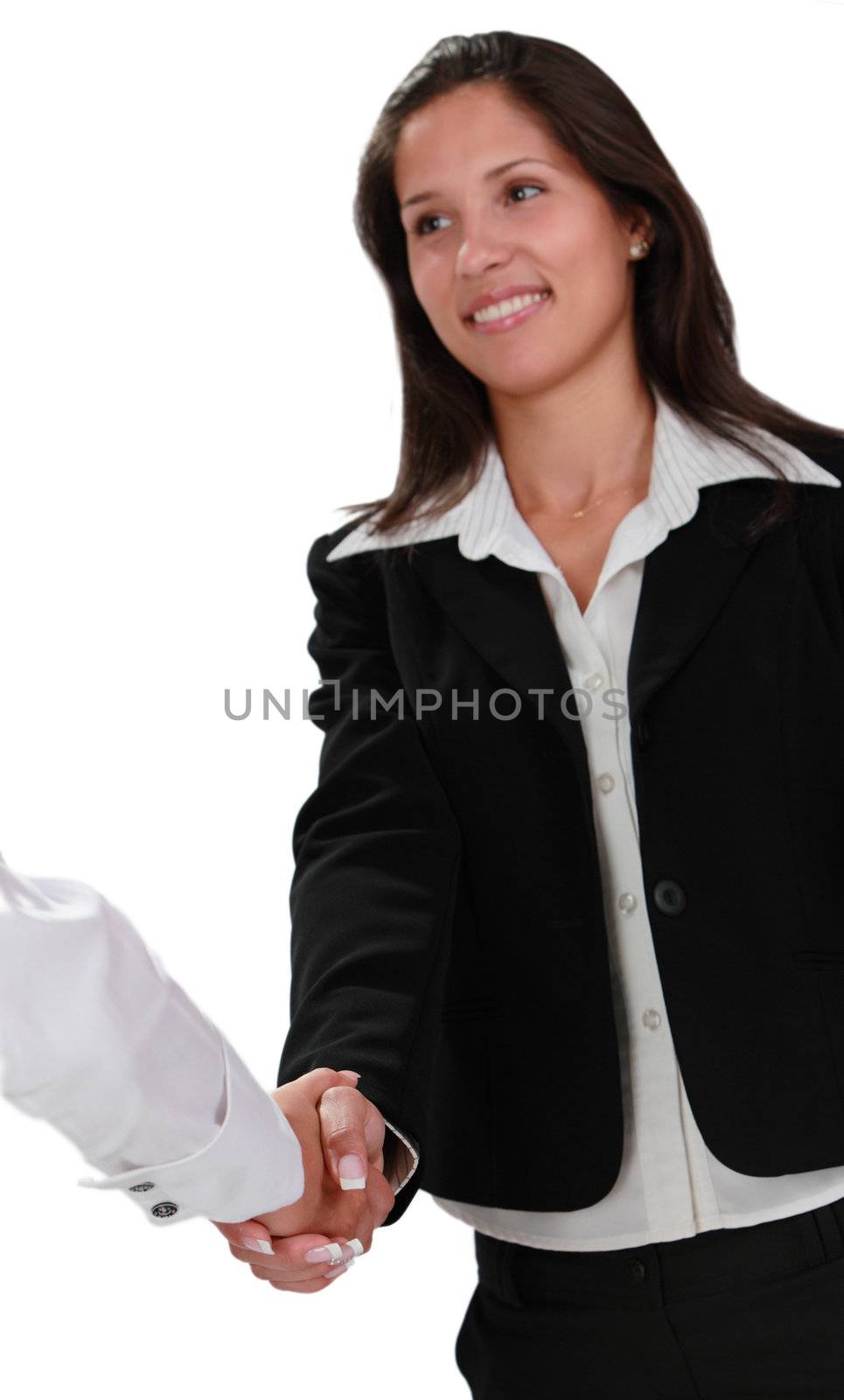 Two businesswoman shaking hands isolated against a white background.Selective focus on the hands.The woman in black suit is not in focus.
