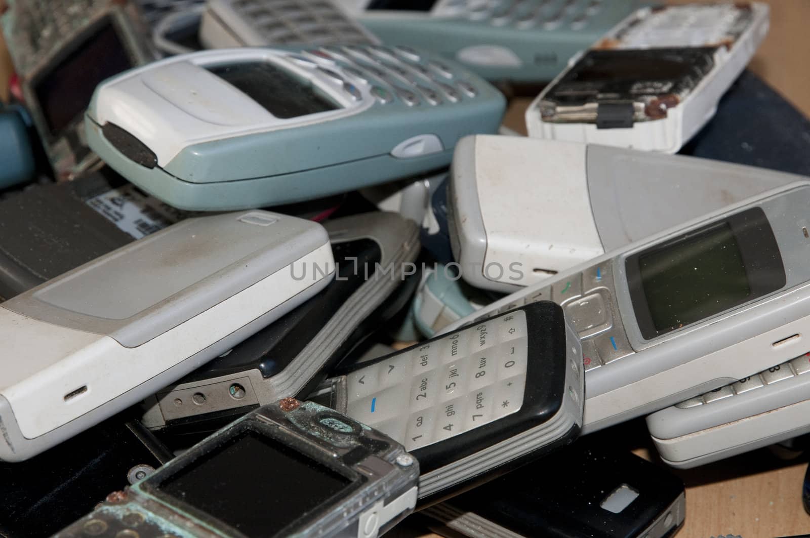 Many old mobile phone in a sort of graveyard
