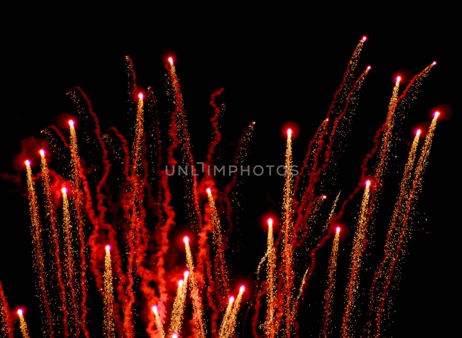 Red and Gold fireworks against the night sky.