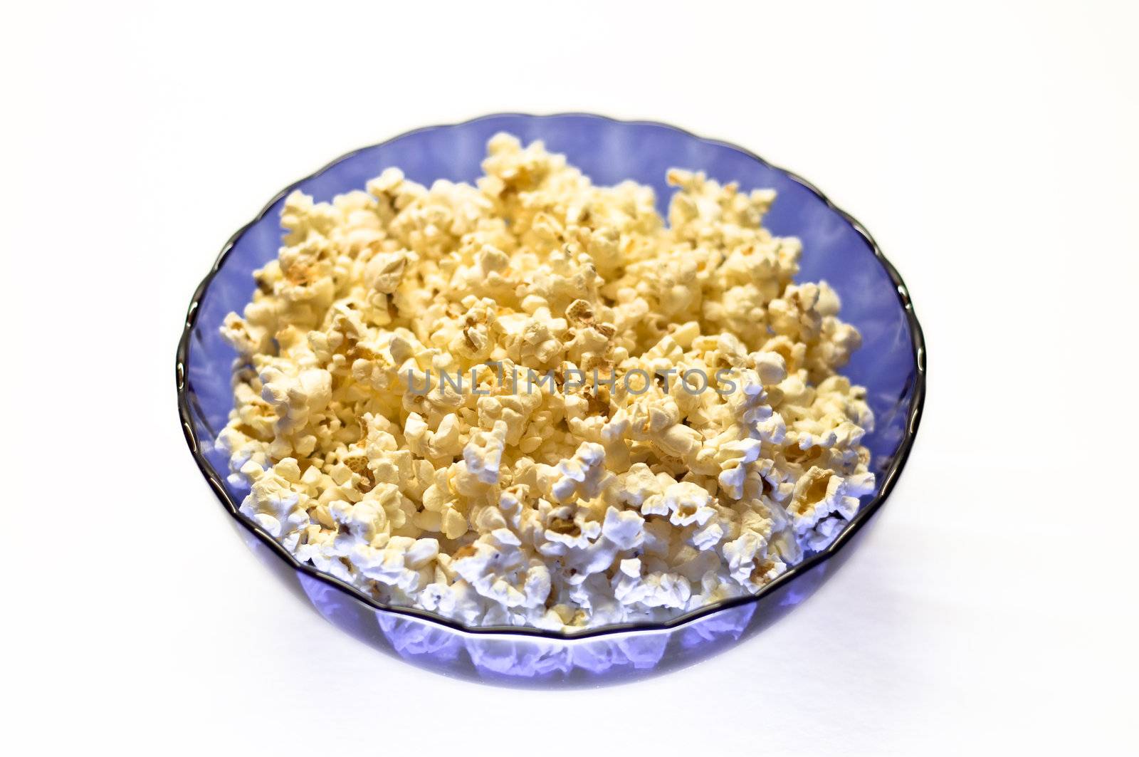 Popcorn in a blue basket. Isolated on a white background.