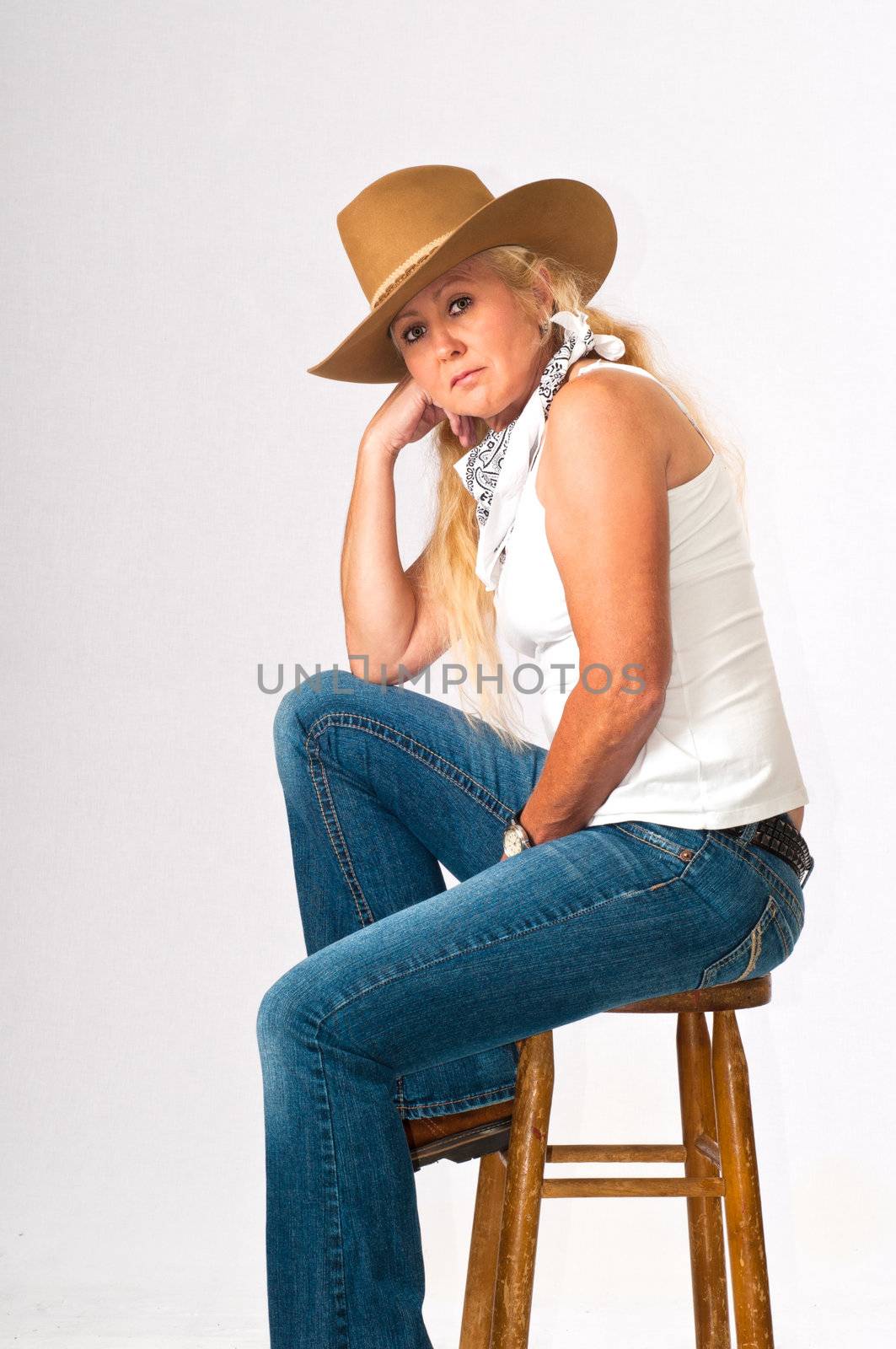 Sexy woman in western clothes and cowboy hat.