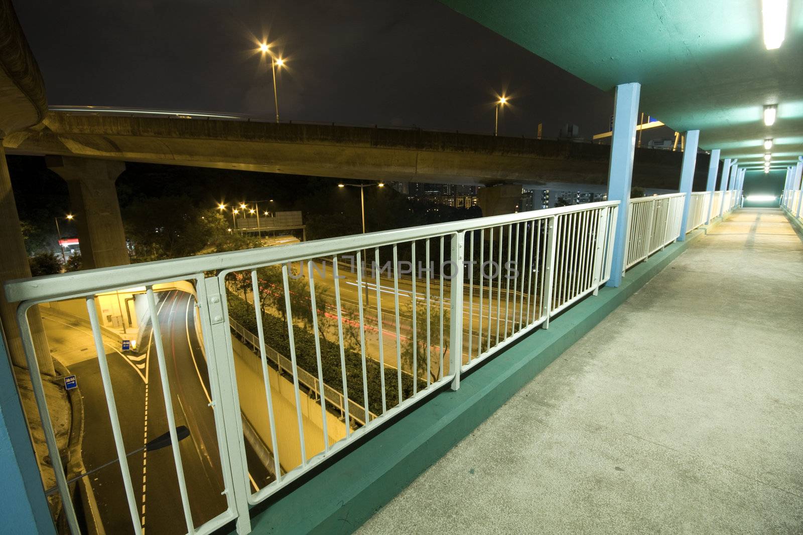 view on footbridge of modern urban city with Freeway Traffic at Night, hong kong