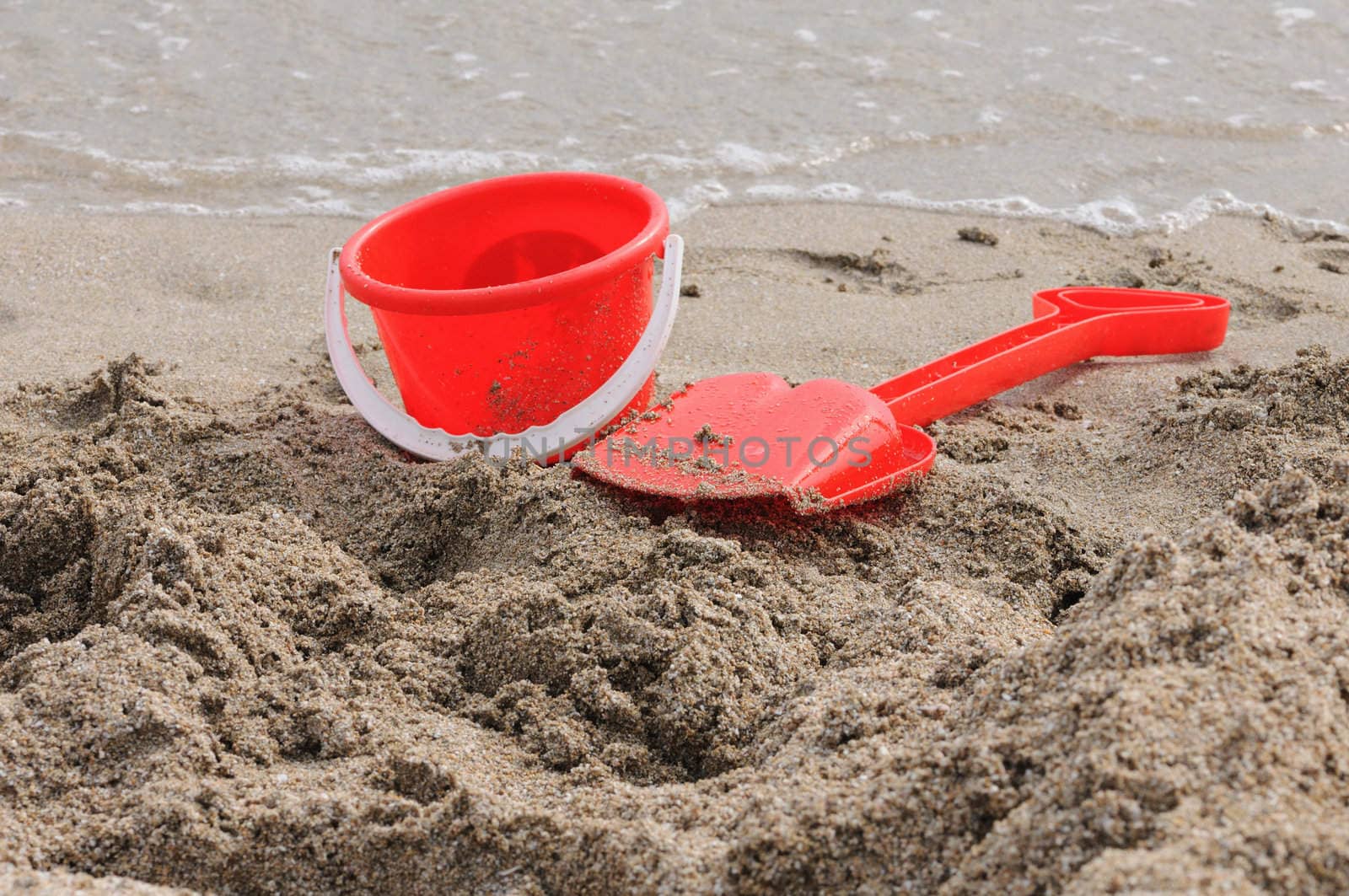 Red Sand Pail and Shovel on a beach