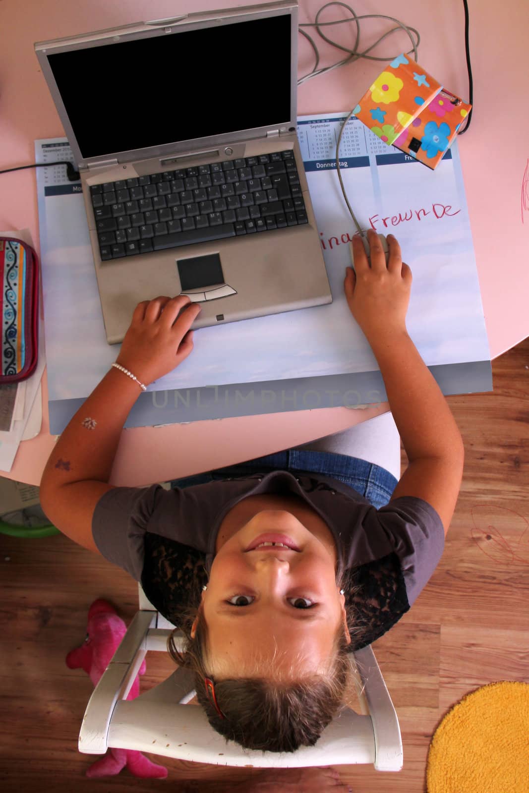 girl is sitting on her desk with a notebook