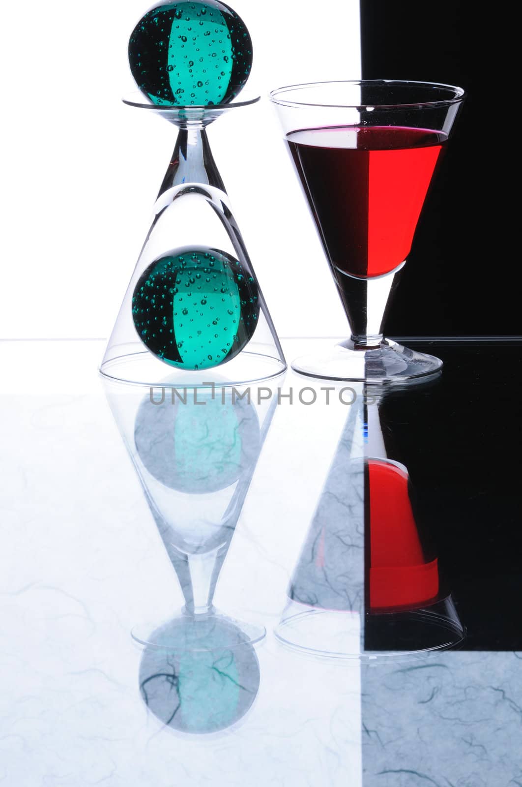 wineglasses and spheres isolated on white and black background