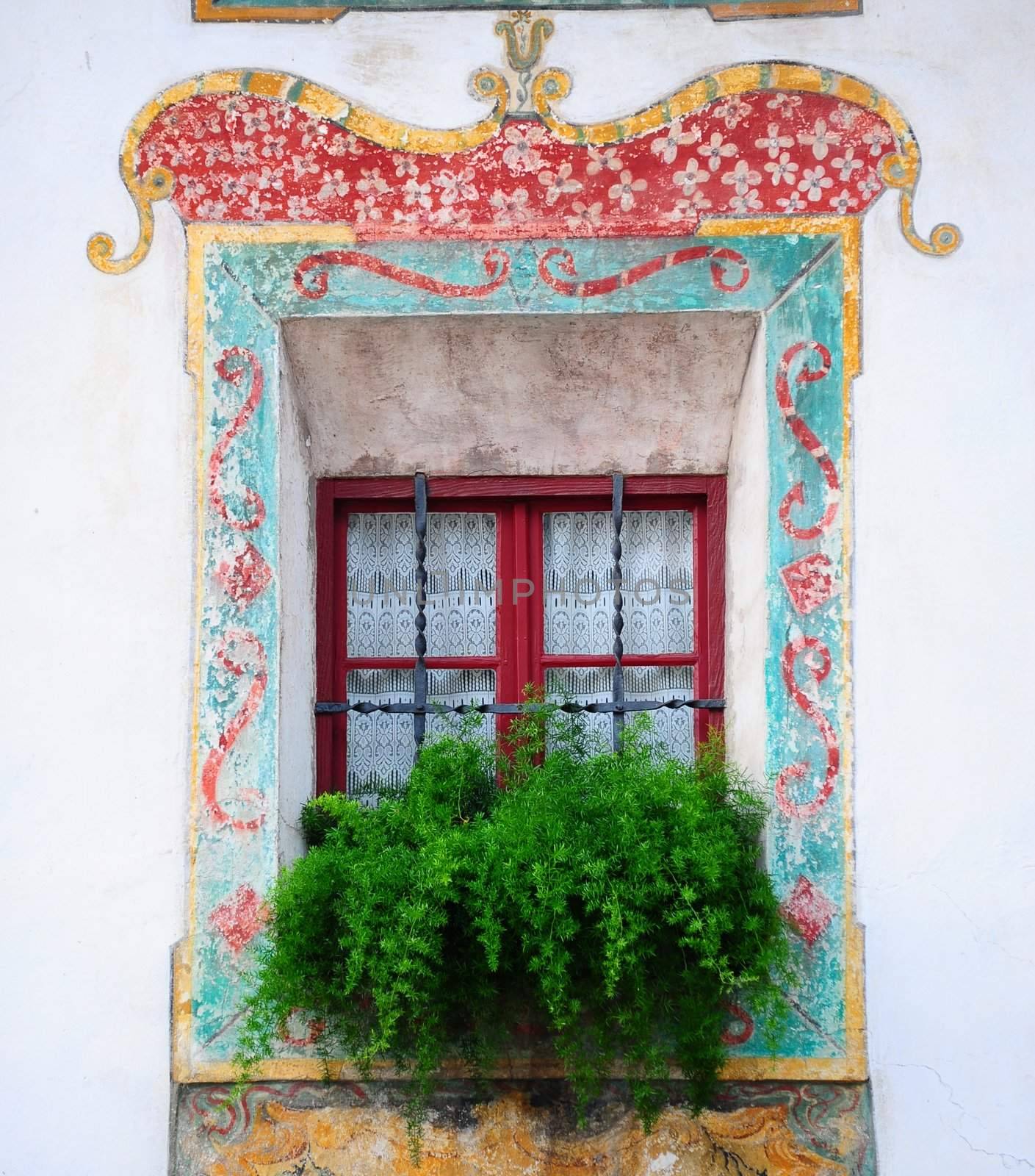 Typical Italian Window  Decorated With Fresh Flowers And Fresco