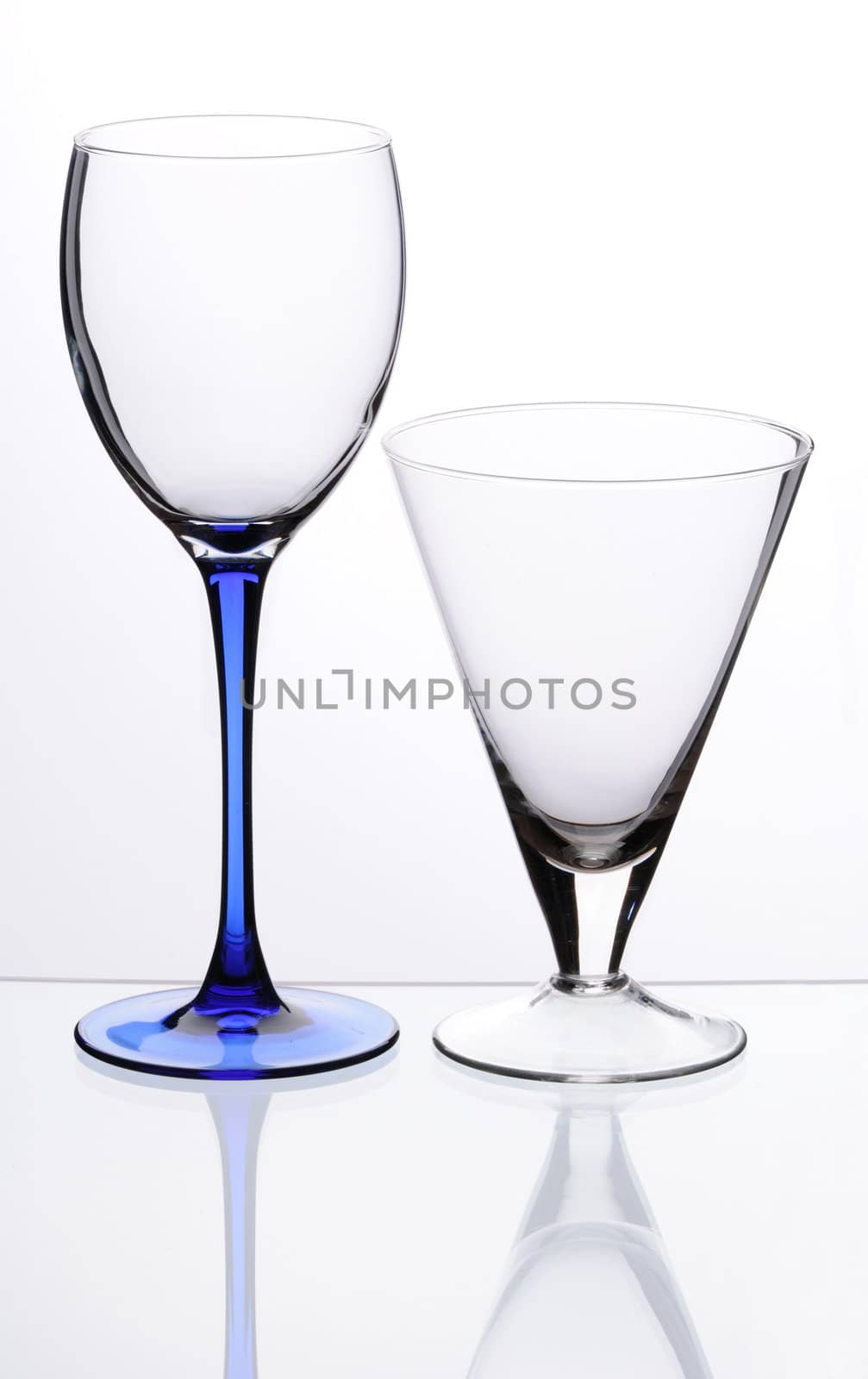 Two transparent empty glasses stand on a table