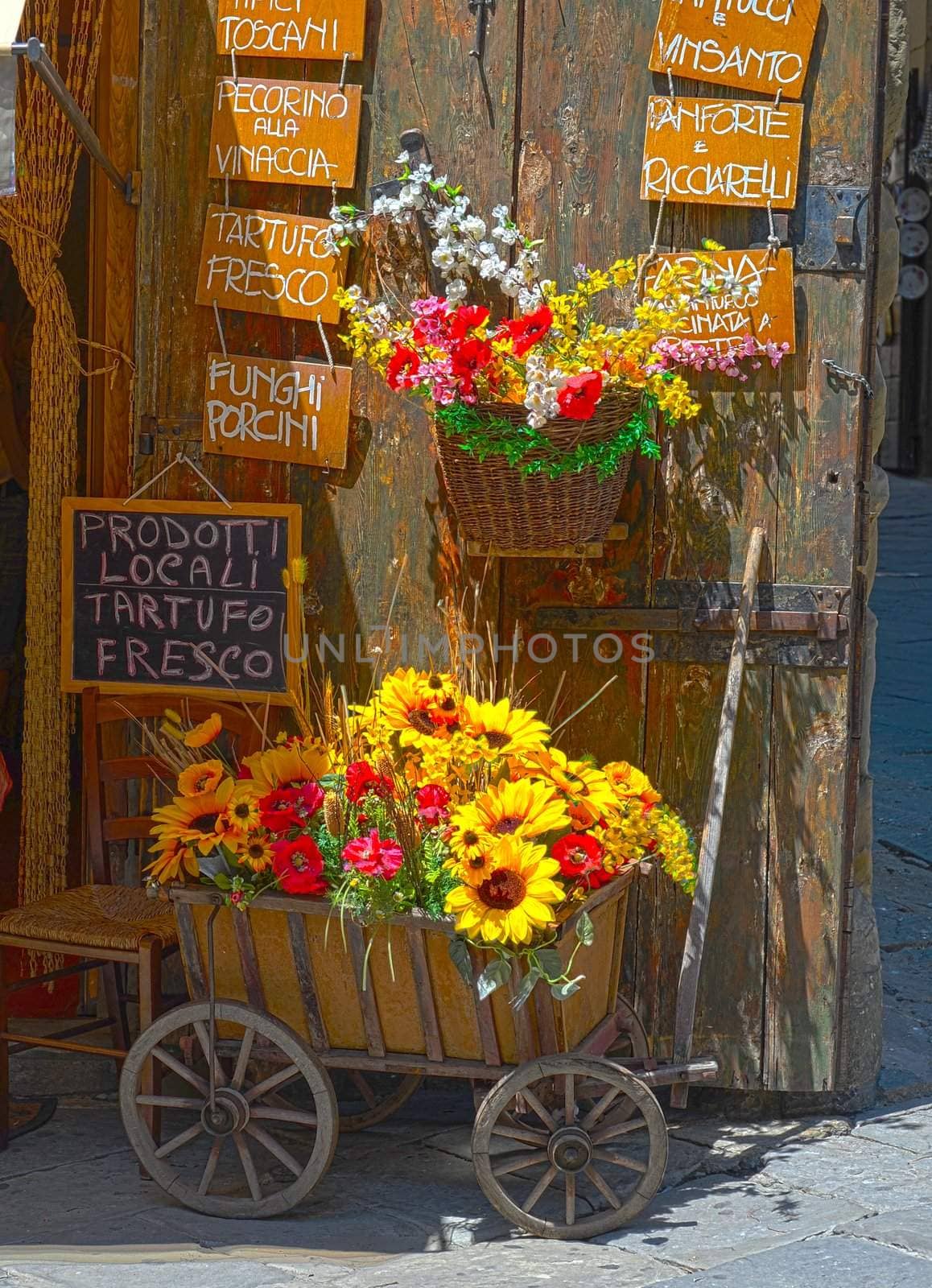 Cart With Artificial Flowers, Standing Near The Wooden Gates