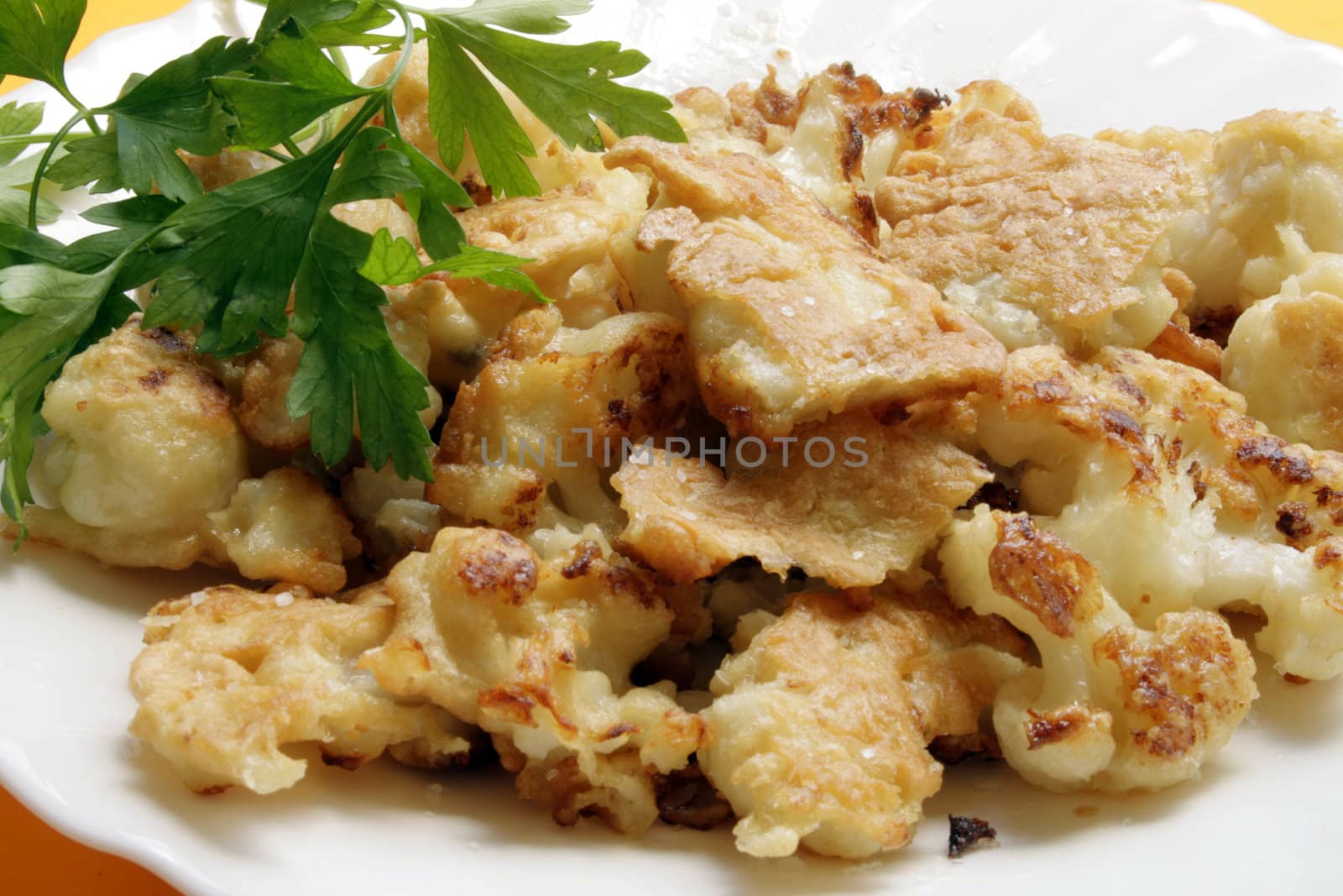 Fried fresh cauliflower with parsley on the plate