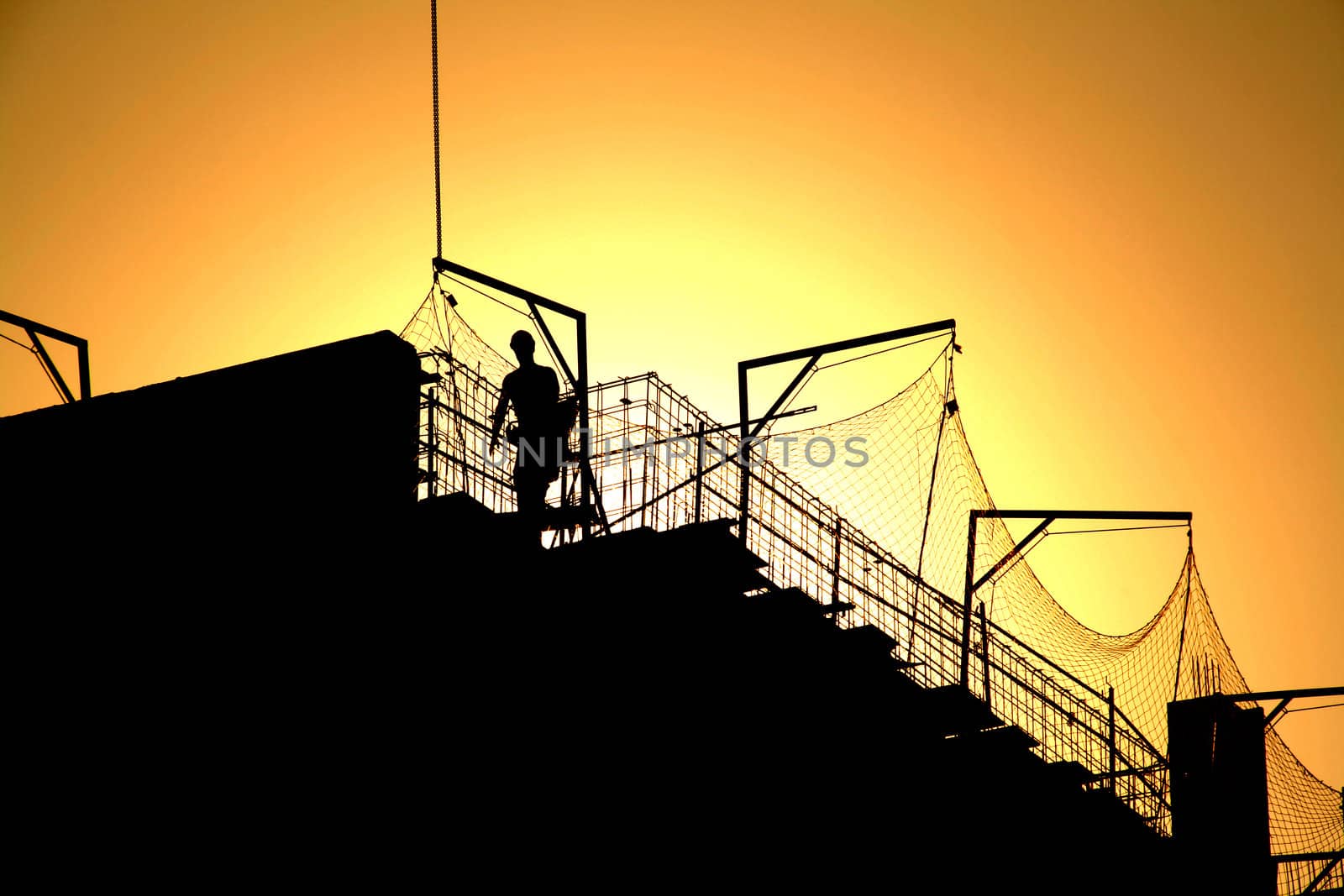 worker and sunset. under construction, working protection.
